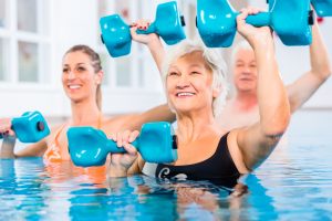 People,Young,And,Senior,In,Water,Gymnastics,Physiotherapy,With,Dumbbells