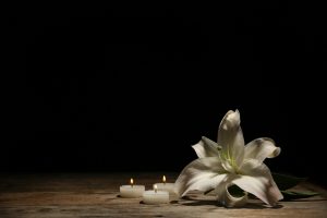 Beautiful,Lily,And,Burning,Candles,On,Dark,Background,With,Space